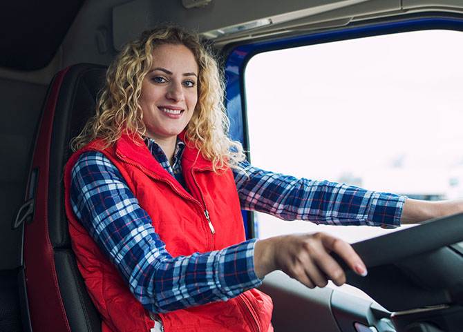 Female trucker sitting in truck cabin